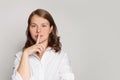 Portrait of woman with finger near lips, secret, silence and gossip concept Royalty Free Stock Photo