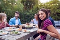 Portrait Of Woman With Friends At Home Sitting At Table Enjoying Food At Summer Garden Party Royalty Free Stock Photo