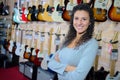 Portrait woman in front display guitars