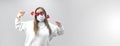 Portrait of woman in funny glasses and medical protective wearing mask holding in hands red hearts. concept of valentines day Royalty Free Stock Photo