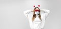 Portrait of woman in funny glasses and medical protective wearing mask holding in hands red hearts. concept of valentines day Royalty Free Stock Photo