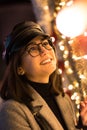 Portrait of a woman gazing at Christmas decoartion outdoors
