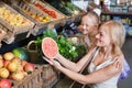 Portrait of woman and girl buying fresh fruits Royalty Free Stock Photo