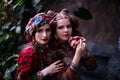 Portrait of woman and girl in ethnic clothes in tropical garden Royalty Free Stock Photo