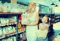 Portrait of woman and girl gladly shopping groats Royalty Free Stock Photo