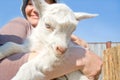 Portrait of woman with goatling.