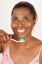 Young girl brushing teeth happily isolated on light background Royalty Free Stock Photo