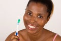 Young girl brushing teeth happily isolated on light background Royalty Free Stock Photo