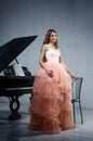 Portrait of woman with grand piano Royalty Free Stock Photo