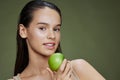 portrait woman green apple near face health Green background Royalty Free Stock Photo