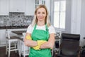 Portrait of woman in green apron and yellow gloves Royalty Free Stock Photo