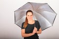 Portrait of woman in grey t-shirt with silver umbrella Royalty Free Stock Photo