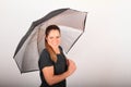 Portrait of woman in grey t-shirt with silver umbrella Royalty Free Stock Photo