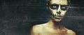 Portrait of woman with Halloween skull make up with space for text. Horror spooky skeleton visage concept. Toned image with film