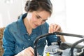 Portrait woman hand fixing engine