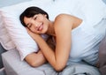 Portrait, woman and happy on bed with pillow, dreaming and healthy body for sleeping. Smiling, blanket and face of Royalty Free Stock Photo