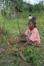 Village life, woman harvesting peanuts