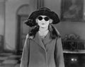 Portrait of woman in hat, sunglasses and coat Royalty Free Stock Photo