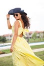 Portrait of a woman with hat and yellow dress