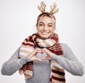 Portrait, woman and heart with smile at Christmas for festive, winter and holiday on studio backdrop. Female person Royalty Free Stock Photo