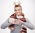 Portrait, woman and heart with smile at Christmas for festive, winter and holiday on studio backdrop. Female person Royalty Free Stock Photo