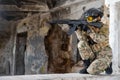 Portrait of a woman in a helmet and goggles with a machine gun in her hands. A female soldier in a camouflage uniform Royalty Free Stock Photo