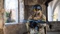 Portrait of a woman in a helmet and goggles with a machine gun in her hands. A female soldier in a camouflage uniform Royalty Free Stock Photo