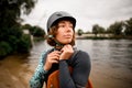 Portrait of woman in helmet and vest who stands on the river bank Royalty Free Stock Photo