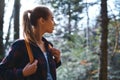 Portrait of a woman hiker walking on the trail in the woods. Royalty Free Stock Photo