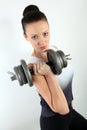 Portrait of a woman holding a big dumpbell for weight lifting workout