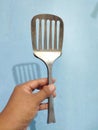 The portrait of a woman holding the broken spatula in her hand Royalty Free Stock Photo