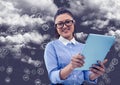 Portrait of woman holding digital tablet with connecting icons and cloud in background