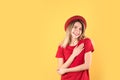 Portrait of woman holding hands near heart on color background