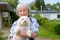 Portrait of a woman holding her dog in her arms Royalty Free Stock Photo