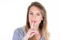 Portrait of woman holding index finger on lips quiet gesture silence sign on white background Royalty Free Stock Photo