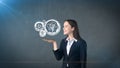 Portrait of woman holding painted watch mechanism on the open hand palm, isolated studio background. Business concept. Royalty Free Stock Photo