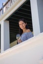 Portrait of woman holding white wine glass in balcony at restaurant Royalty Free Stock Photo