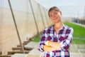 Portrait of woman horticulturist standing in hothouse