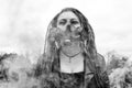 Portrait of a Woman in a jacket and dreadlocks in a gas mask with spikes. woman standing in smoke. Black and white photo Royalty Free Stock Photo