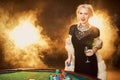 Portrait of woman keeping poker chips near table in casino Royalty Free Stock Photo