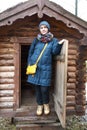 Portrait of woman on log cabin background