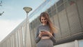 Portrait woman looking at smartphone while running outdoor. Close-up Of A Young Beautiful Sports Fitness Girl Holding A Royalty Free Stock Photo