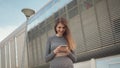 Portrait woman looking at smartphone while running outdoor. Close-up Of A Young Beautiful Sports Fitness Girl Holding A Royalty Free Stock Photo
