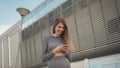 Portrait woman looking at smartphone while running outdoor. Close-up Of A Young Beautiful Sports Fitness Girl Holding A Royalty Free Stock Photo