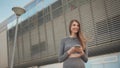 Portrait woman looking at smartphone while running outdoor. Close-up Of A Young Beautiful Sports Fitness Girl Holding A Royalty Free Stock Photo