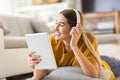 Woman lying on the floor and listening to music Royalty Free Stock Photo