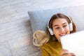 Woman lying on the floor and listening to music Royalty Free Stock Photo