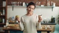 Woman making choice between apple and cake in kitchen. Girl choosing fruit diet. Royalty Free Stock Photo