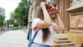 Portrait of young woman making photos of old building with vintage film camera Royalty Free Stock Photo