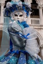 Portrait of woman in beautiful blue costume, hat and mask at the Doges Palace, Venice, during the carnival